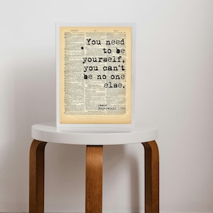 May include: A framed print of a quote on a vintage book page. The quote reads "You need to be yourself, you can't be no one else." The quote is attributed to Casia Supersonic (1994).