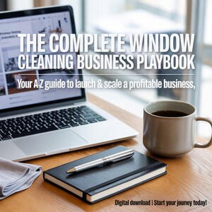 May include: A laptop, notebook, pen, and coffee mug sit on a wooden desk. The laptop screen displays a website. The notebook is black with a silver pen resting on top. The mug is beige and filled with coffee. Text reads: "THE COMPLETE WINDOW CLEANING BUSINESS PLAYBOOK."