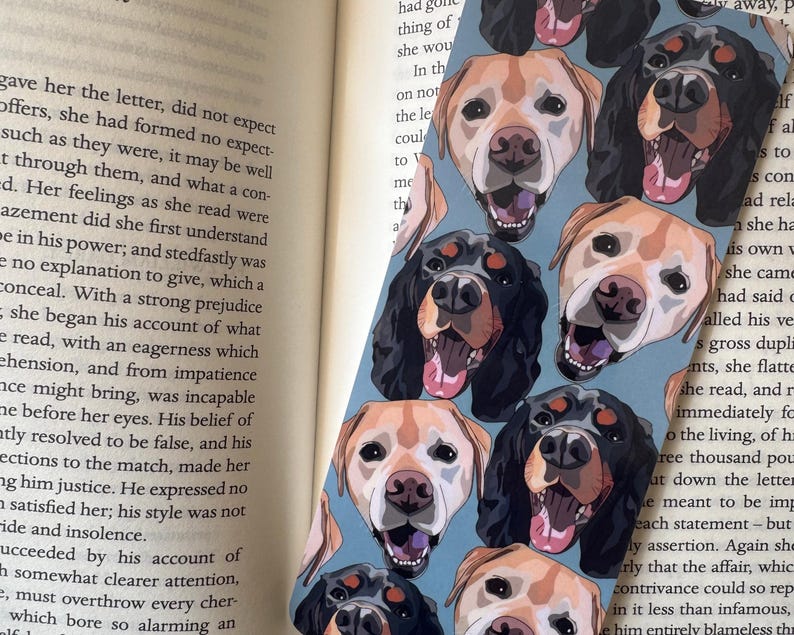 Personalised pet bookmark placed inside open book, custom dog or cat portrait reading accessory thoughtful gift for bookworms.