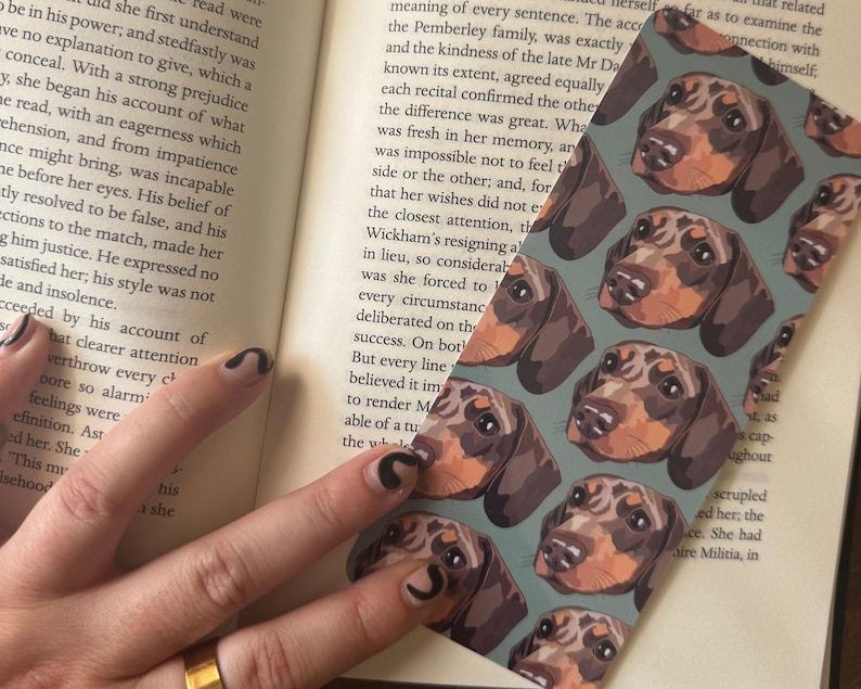 Close up of personalised pet portrait bookmark showing detailed fine line dog or cat face illustration custom reading accessory