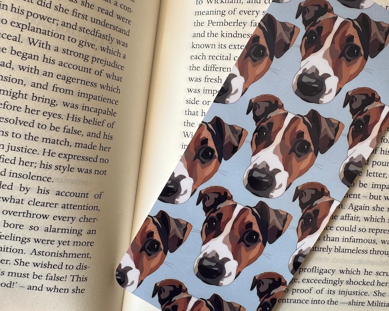 Personalised pet bookmark placed inside open book, custom dog or cat portrait reading accessory thoughtful gift for bookworms.