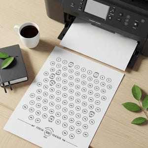 May include: A printable 100 day streak tracker with a black and white design. The tracker is a grid of 100 circles, numbered 1 to 100. The text "Streak 100 Days" is at the bottom of the page.