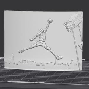 May include: A grayscale relief sculpture featuring a basketball player mid-air, reaching for the ball. The design includes a basketball hoop and a cityscape silhouette at the base. The overall theme is sports and basketball.