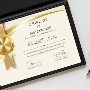 May include: A certificate of appreciation with a gold seal and ribbon, presented to Rachelle Justin for her dedication and hard work at Ingoude Company. The certificate is signed by Jonathan Patterson and Francisco Andrade.