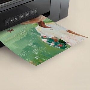 May include: A printer with a green and white painting being printed. The painting features a person with a red and green hat and a white shirt.