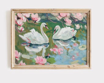May include: A framed painting depicts two white swans on a pond with pink water lilies and green lily pads. The water reflects the swans and the surrounding foliage. The painting has a gold-colored frame.
