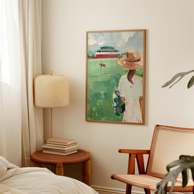 May include: A painting of a woman in a straw hat standing in a field, watching a horse race. The woman is wearing a white dress with a floral pattern. The painting is in a wooden frame.