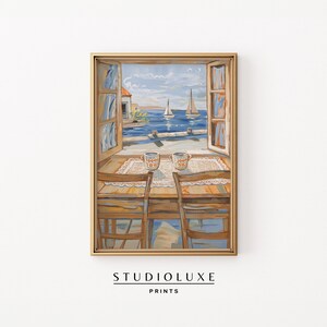 May include: A painting of a window with a view of a seascape with two sailboats. The window is open and there are two mugs on a table in front of it. The table is set with a white tablecloth and there are two chairs.