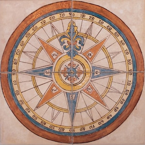 May include: A decorative compass tile with a blue, yellow, and orange design. The compass features a fleur-de-lis in the center and the cardinal directions are labeled in English. The tile is surrounded by a brown border with numbers from 10 to 90.