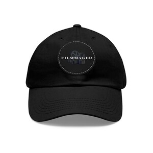 May include: Black baseball cap with a black and white circular patch that says "FILMMAKER" with a film reel graphic.