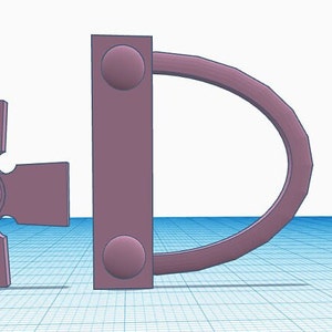 May include: A 3D-rendered image featuring two objects in a muted purple hue. One object is a cross-shaped design with a central circular element. The other is a D-shaped object attached to a rectangular piece with two circular accents.
