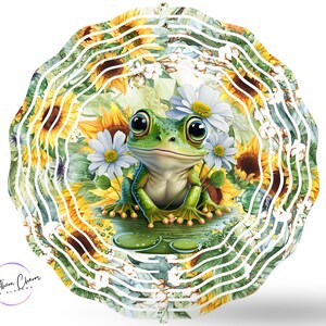 May include: A green frog with large eyes sits on a bed of green lily pads surrounded by sunflowers and white daisies. The background is a circular pattern of white lines on a green and yellow background.