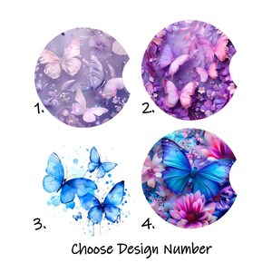 May include: Four car coasters with butterfly designs. The coasters are round with a curved cutout. Designs include butterflies in shades of purple, blue, and pink, with floral accents. Text at the bottom reads "Choose Design Number."