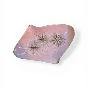 May include: A set of three ceramic mugs with a speckled, cream-colored glaze. Each mug features a different hand-painted floral design in shades of blue, green, and yellow. The mugs have a simple, modern shape.