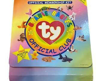 May include: A colorful Beanie Babies Official Club membership kit. The box features a rainbow design with the words "Official Membership Kit" and "Beanie Babies Official Club." The kit includes a free poster. The "ty" logo is in the center.