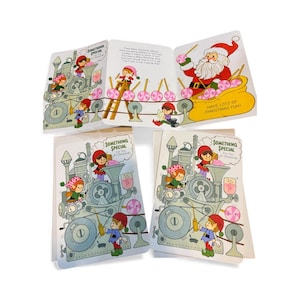 May include: A vintage Christmas-themed greeting card set. The cards feature illustrations of elves, Santa Claus, and a candy-making machine. The text on the cards reads "Something Special" and "Have Lots of Christmas Fun!"