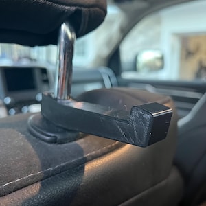 Headrest bow hanger / bag hanger