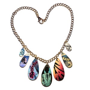 May include: A gold chain necklace with multiple teardrop-shaped pendants. Each pendant is made from a comic book page with colorful illustrations and text, including "SHSSSSS" and "KRAK".