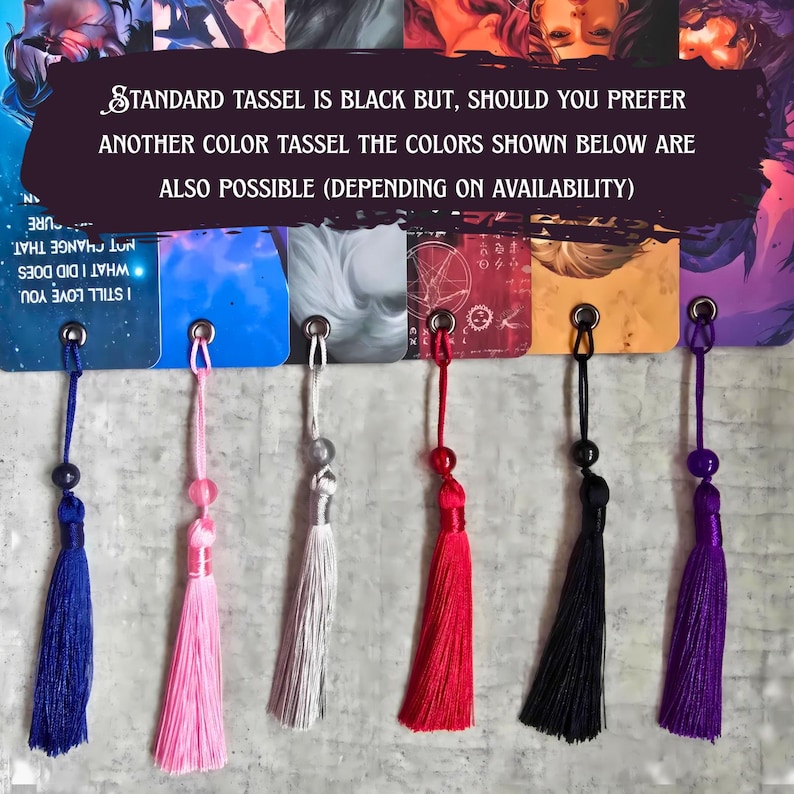 May include: A selection of colorful tassels in blue, pink, silver, red, black, and purple. Each tassel is attached to a small tag with a metal eyelet. The text on the tags reads "STANDARD TASSEL IS BLACK BUT, SHOULD YOU PREFER ANOTHER COLOR TASSEL THE COLORS SHOWN BELOW ARE ALSO POSSIBLE (DEPENDING ON AVAILABILITY)"
