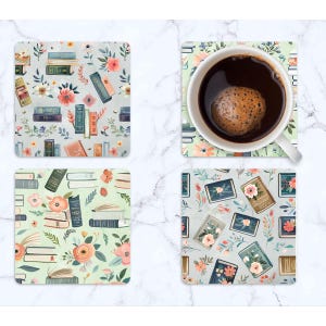 May include: Four square coasters with floral and book designs. One coaster holds a white mug filled with coffee. The coasters feature various book illustrations, flowers, and a light colour palette of green, pink, and blue.