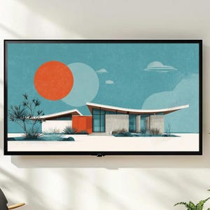 May include: A framed art print featuring a mid-century modern house illustration. The artwork showcases a house with a flat roof, large windows, and a vibrant orange accent wall. The background is a teal sky with a large orange sun and a white moon.