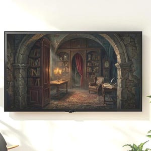 May include: A framed print depicting a gothic library scene. The artwork features stone archways, bookshelves filled with books, a candelabra, and a red curtain. A vintage armchair and a writing desk are also visible.