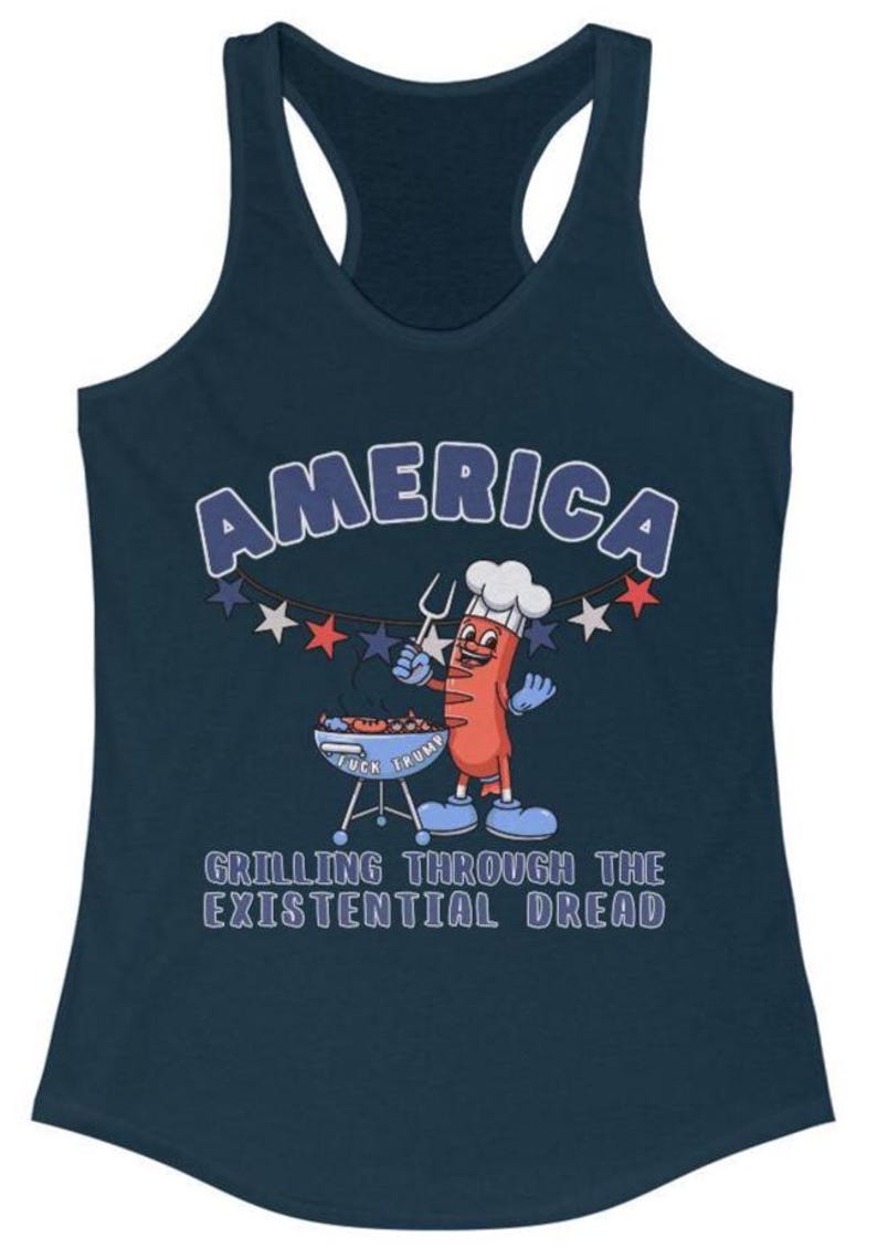 May include: Navy blue tank top with the word "AMERICA" in white outlined in blue. A cartoon hot dog character is grilling on a barbecue. The text "GRILLING THROUGH THE EXISTENTIAL DREAD" is below the graphic.