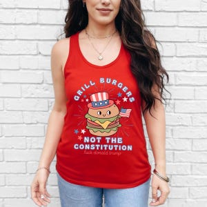May include: Red tank top featuring a burger illustration wearing a patriotic hat and holding a small American flag. The text reads "Grill Burgers Not The Constitution" with additional text below.