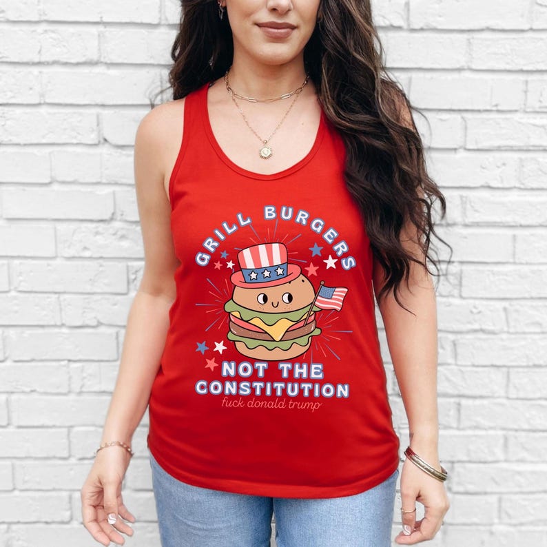 May include: Red tank top featuring a burger illustration wearing a patriotic hat and holding a small American flag. The text reads "Grill Burgers Not The Constitution" with additional text below.