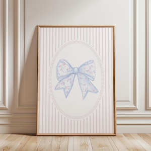 Add soft feminine charm to your baby girl’s room with this coquette nursery print featuring a delicate watercolor floral bow in pastel blue and pink. Perfect for bow nursery decor, clean girl wall art, or pink nursery wall paintings, this grandmillennial nursery art digital download blends vintage elegance with modern coquette style. Print instantly to create sweet bow wall decor for your nursery or girls room.