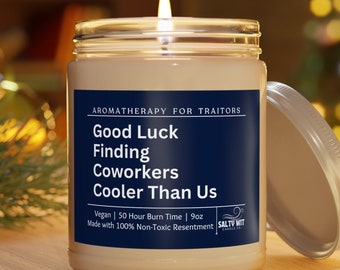 May include: A white candle jar with a blue label that reads "AROMATHERAPY FOR TRAITORS Good Luck Finding Coworkers Cooler Than Us Vegan | 50 Hour Burn Time | 9oz Made with 100% Non-Toxic Resentment SALTY WIT CANDLES"