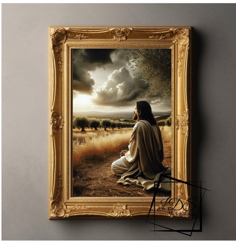May include: A painting of Jesus in a field, kneeling and praying with his hands clasped. The sky is cloudy and the sun is setting in the distance. The painting is framed in a gold frame.