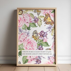 May include: A framed print with a floral design featuring pink roses, purple irises, and yellow butterflies. The print includes the text "CREATE IN ME A CLEAN HEART O GOD; AND RENEW A RIGHT SPIRIT WITHIN ME. Psalm 51:10"