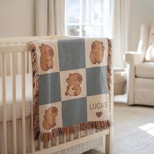 Personalized Capybara Blanket – This cozy woven baby name blanket features an adorable capybara design, perfect for a capybara nursery or animal-themed baby shower. A thoughtful and unique heirloom gift for newborns, toddlers, or young kids, this personalized blanket adds a charming touch to any nursery. Great as a Christmas gift, birthday present, or custom baby throw for capybara lovers. Whether you're decorating a baby boy’s room or looking for a one-of-a-kind capybara baby shower gift.