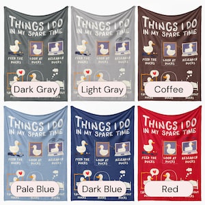 May include: Six different colored fleece blankets with the text "Things I do in my spare time" and a cartoon image of ducks. The blankets are in the colors dark gray, light gray, coffee, pale blue, dark blue, and red.