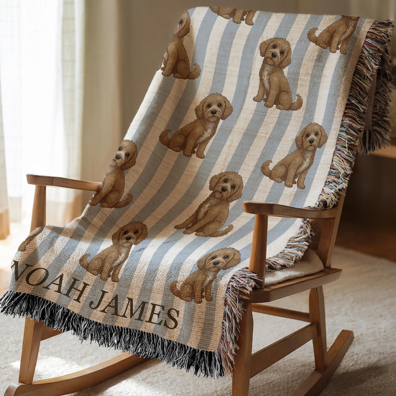 Personalized Goldendoodle dog baby blanket featuring a Goldendoodle puppy illustration, blue striped nursery design, and custom name detail. This custom name dog throw is designed as a puppy lover gift and newborn shower present for boys, blending dog-themed nursery decor with a clean, playful Goldendoodle style that suits baby nurseries and dog-loving families.