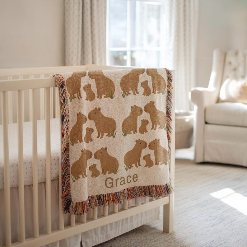 Custom Capybara Name Blanket – Personalized Woven Baby Blanket for Nursery Decor and Gifts
Celebrate a new arrival with this adorable personalized capybara baby blanket. Made with heirloom-quality woven fabric, this cozy blanket features a sweet capybara design and your chosen name, making it a perfect keepsake. Ideal for baby showers, first birthdays, or Christmas gifts, it’s a charming addition to any capybara-themed nursery or animal-lover’s room. A thoughtful gift for toddlers and kids.
