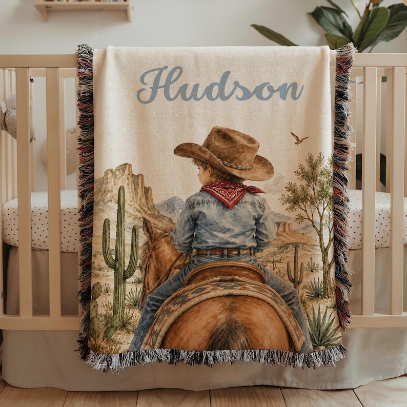 Western cowboy baby blanket personalized with baby name details, cowboy nursery artwork, and rodeo horse inspired style for a baby boy blanket or cowboy baby shower gift. This custom baby blanket is perfect for western baby gift ideas, toddler boy gifts, blanket for kids décor, and baby keepsake displays. A unique baby boy gift for families who love horseback riding, first rodeo themes, Southwest nursery style, and cowboy baby blankets.