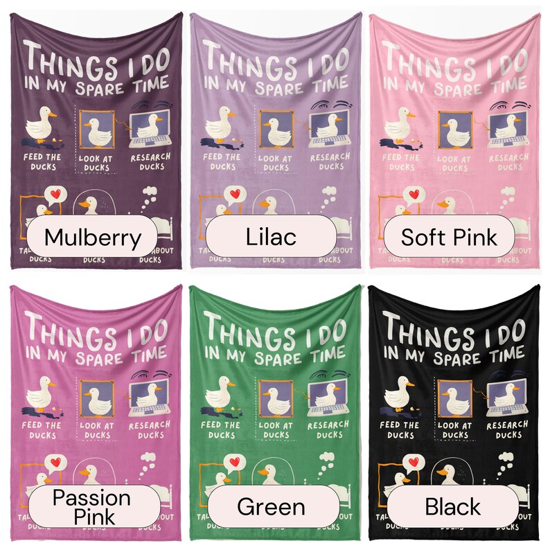 May include: Six different colored fleece blankets with the text "Things I do in my spare time" and a cartoon duck doing different activities. The blankets are in the colors mulberry, lilac, soft pink, passion pink, green, and black.