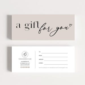 May include: A gift voucher with a pale beige top section featuring the text "a gift for you" in black script. The lower section has fields for recipient, sender, amount, and expiry. Includes business contact details.