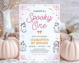 May include: A white rectangular invitation card featuring pink text that reads Charlotte is a Spooky One and Charlotte's 1st Boo-Day. The design includes illustrations of four ghosts wearing pink bows, orange bows, spider webs, and small bats.