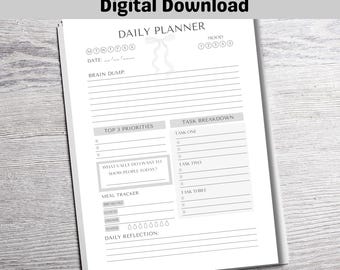 May include: A printable daily planner with a gray and white color scheme. The planner includes sections for daily tasks, meal tracking, and reflection. The text "DAILY PLANNER" is at the top of the page.