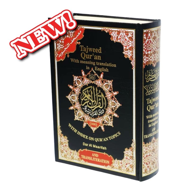 May include: A black hardcover book with gold lettering titled "Tajweed Qur'an" with the words "With meaning translation in English" and "CODED WITH INDEX ON QUR'AN TOPICS" printed on the front cover. The book is published by Dar Al Maarifah and includes transliteration.