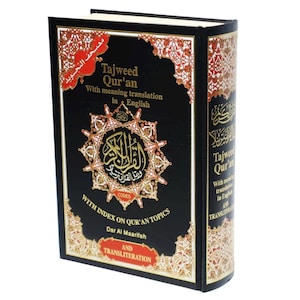 May include: Black hardcover book with gold lettering titled "Tajweed Qur'an" with meaning translation in English. The book has a gold and red decorative border and includes an index on Qur'an topics and transliteration.