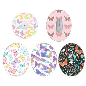 May include: Five different designs for a round, adhesive sticker with a butterfly theme. The stickers are designed to cover a medical device. The designs include butterflies in various colors and patterns, including watercolor, floral, and geometric.