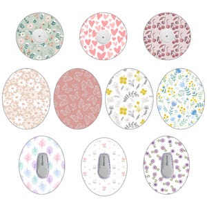 May include: Ten different designs for insulin pump covers. The designs include floral patterns, hearts, butterflies, and cherries. The covers are round and have a white background.