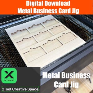 May include: A wooden jig with eight cutouts for making metal business cards. The jig is on a laser cutter bed with a black grid pattern. The text "Digital Download Metal Business Card Jig" is at the top of the image.