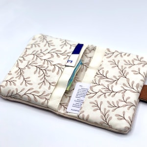 May include: A beige fabric wallet with a brown floral pattern. The wallet has multiple slots for cards and cash. The wallet is open and there are cards and cash inside.