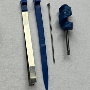 May include: A set of four tools for watch repair, including a pair of tweezers, a blue plastic tool, a small metal needle, and a blue plastic tool with a spiral handle.