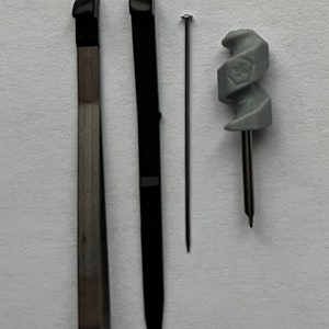 May include: Three tools for crafting: a black metal tool with a pointed tip, a silver metal tool with a flat tip, and a gray plastic tool with a spiral design.